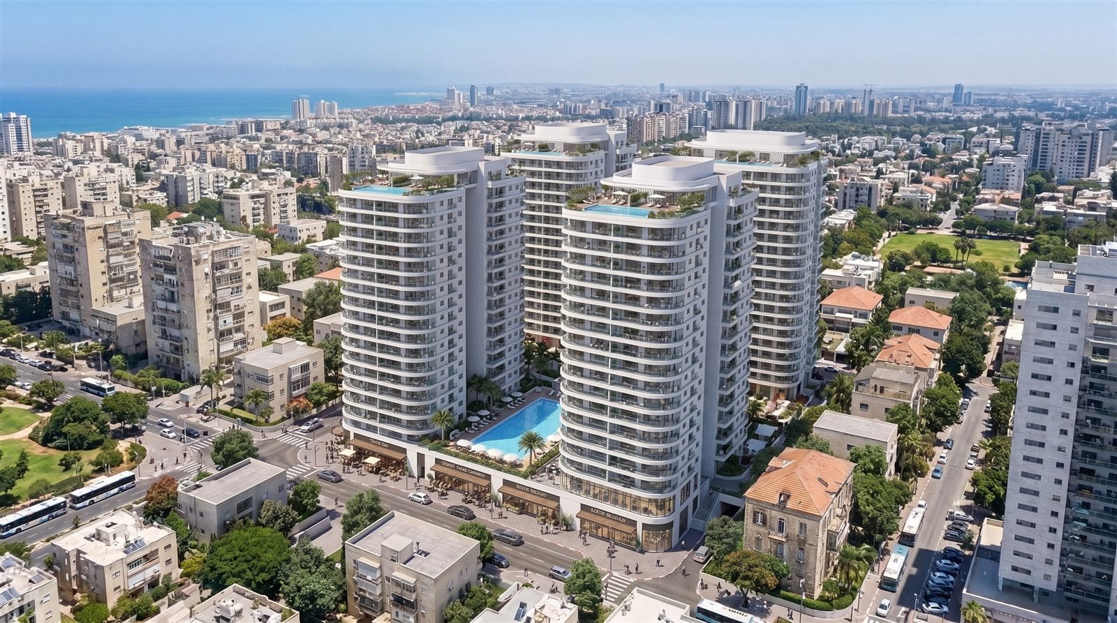 הדמיה אווירית של שלושה מגדלי מגורים לבנים עם בריכות גג, בין בניינים ותיקים ורחובות עירוניים, והים ברקע